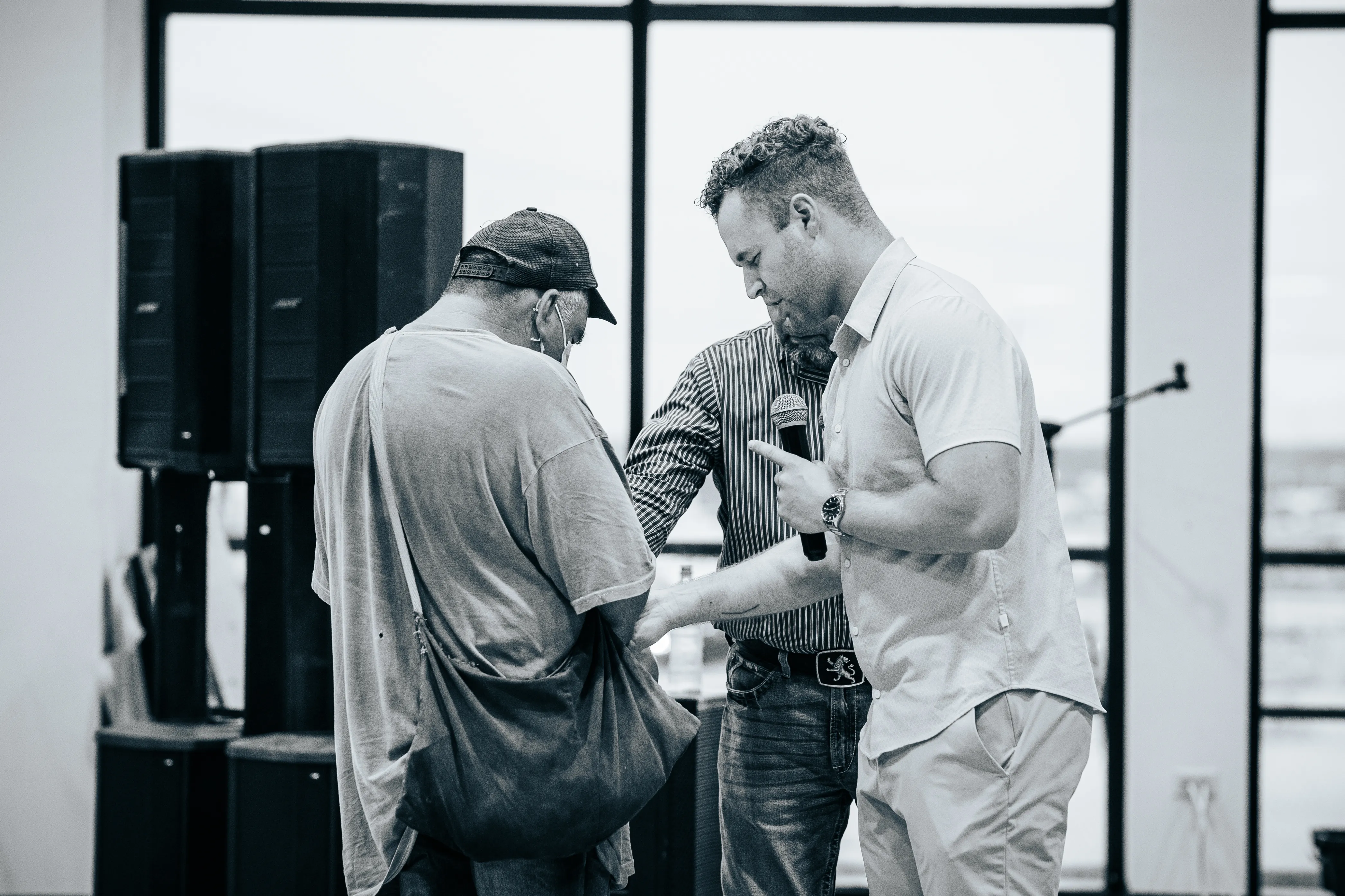 Evangelist Grayson Wilson praying with an elderly man