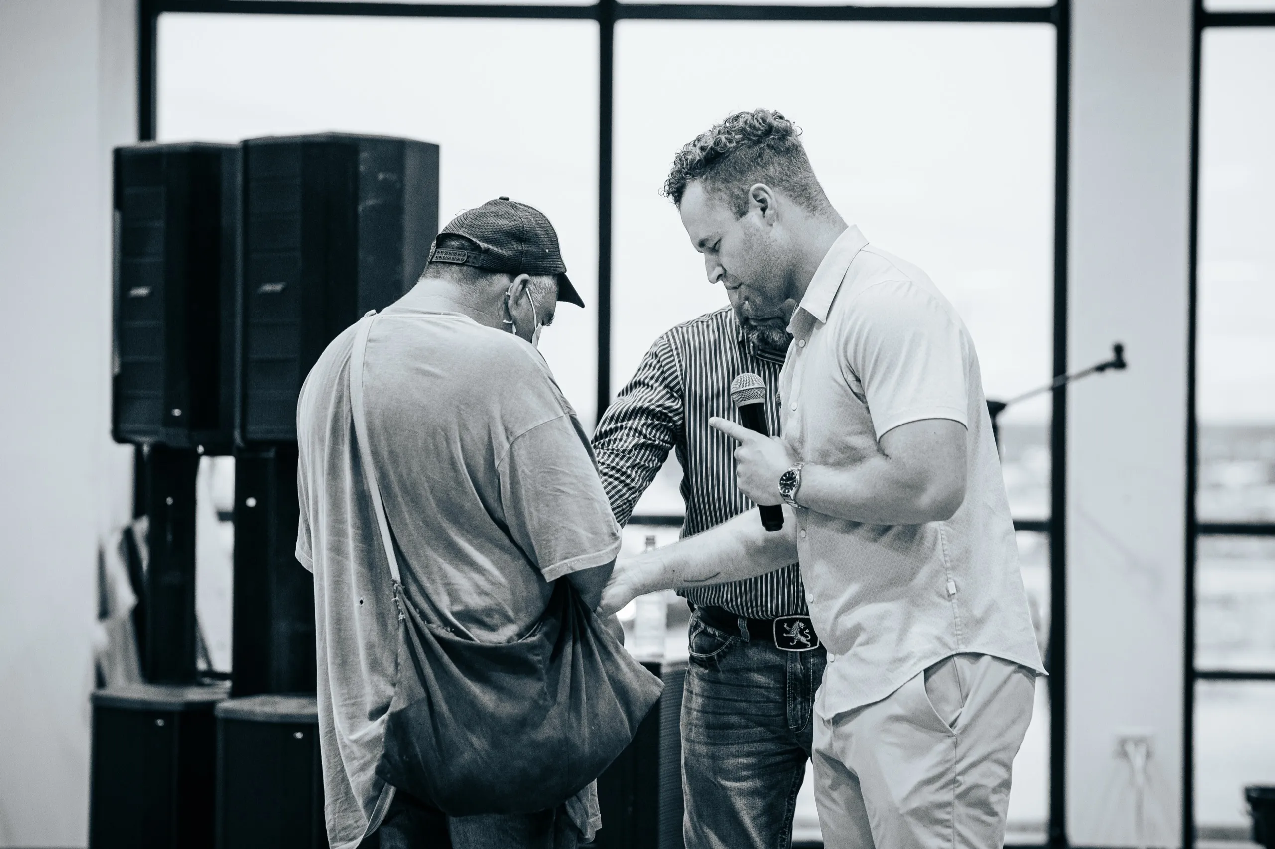 Evangelist Grayson Wilson praying with an elderly man